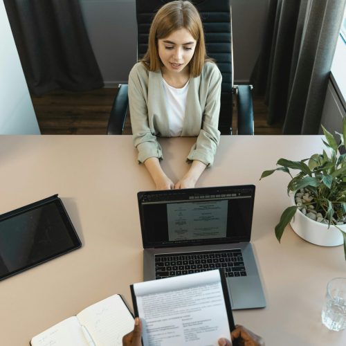 High-angle view of a job interview in a modern office setting, capturing professionalism.